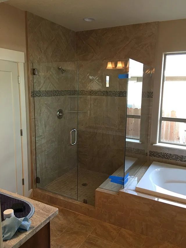 A bathroom with a walk-in shower and a bathtub