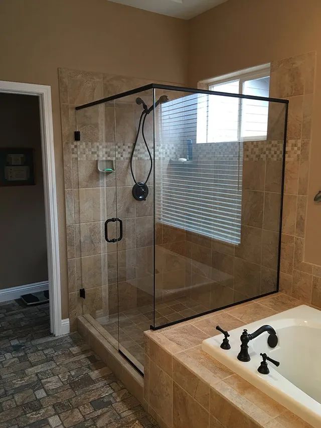 A bathroom with a walk-in shower and a bathtub