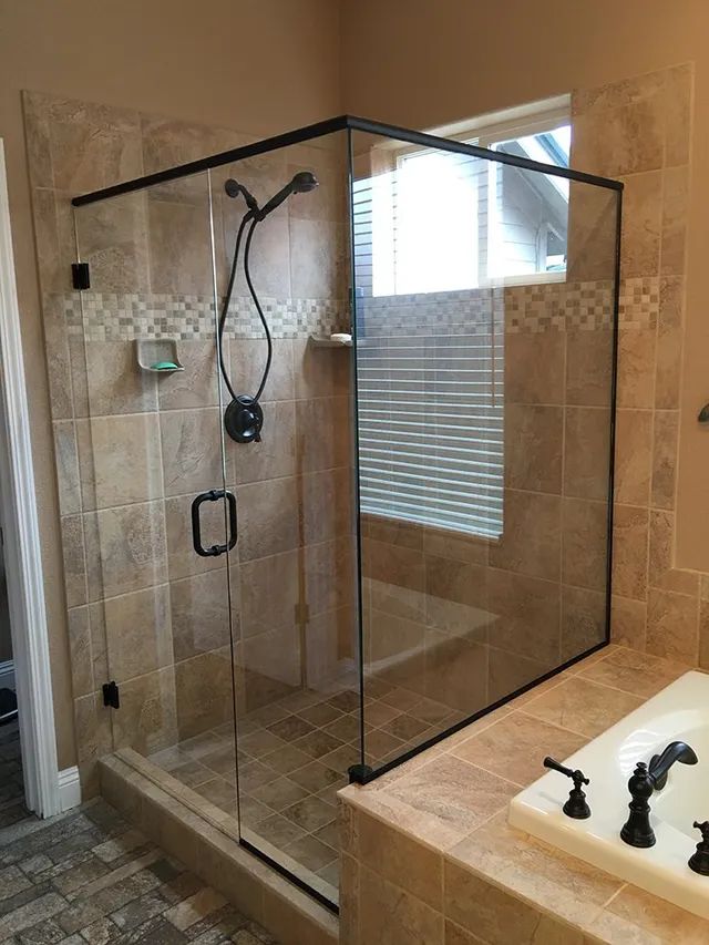 A bathroom with a walk-in shower and a bathtub