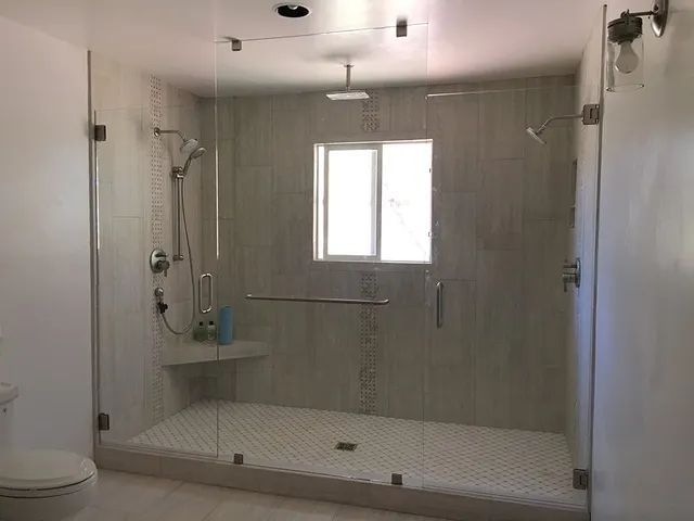 A bathroom with a walk-in shower and a toilet