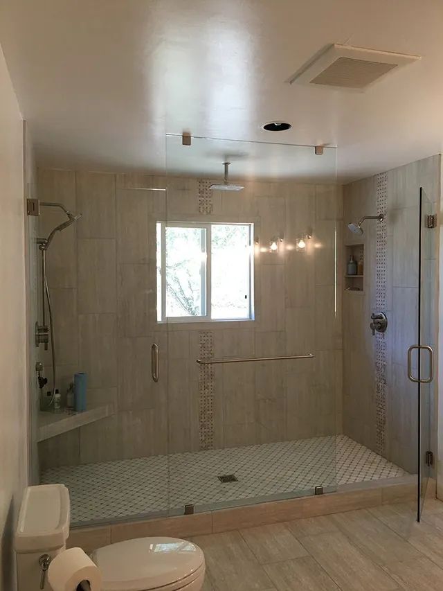 A bathroom with a walk-in shower and a toilet