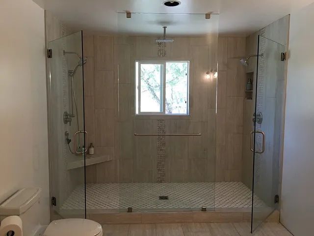 A bathroom with a walk-in shower and a toilet