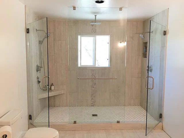 A bathroom with a walk-in shower and a toilet