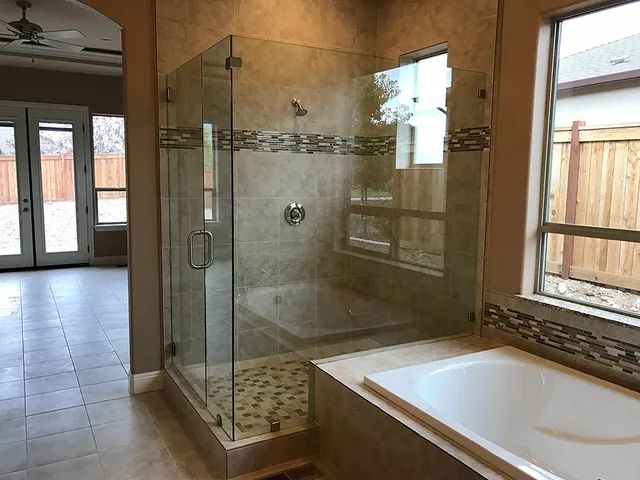 A bathroom with a walk-in shower and a bathtub