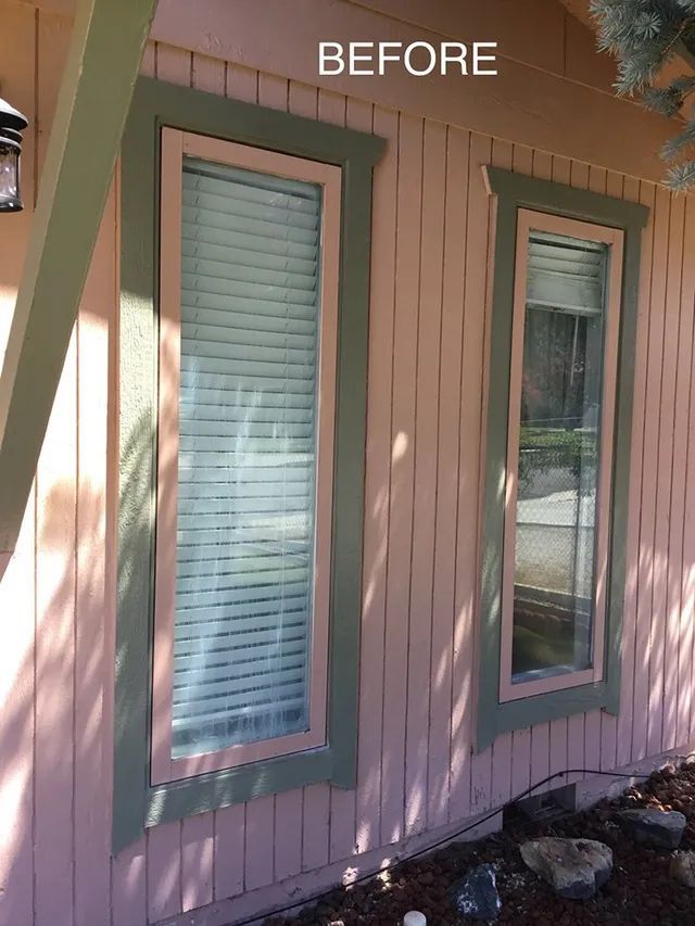 A before picture of a house with a window and pink siding