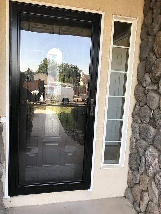 A black glass door with a window on the side of a house