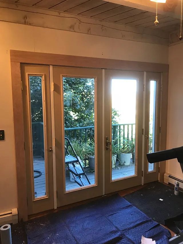 A room with double entry doors and windows