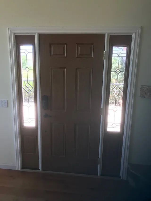 A brown door with stained glass windows in a room