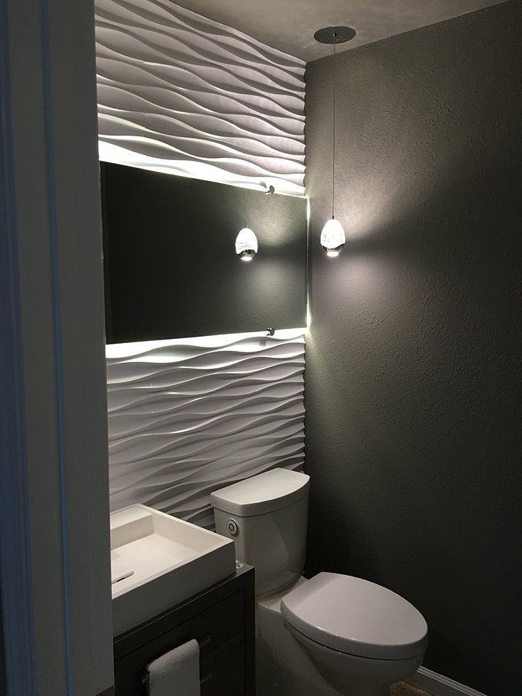 A bathroom with a toilet, sink and mirror