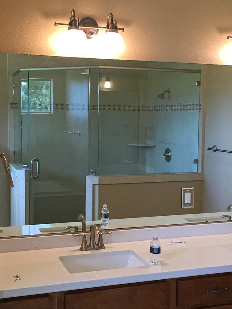 A bathroom with a sink and a large mirror