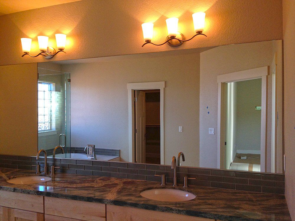 A bathroom with two sinks and a large mirror