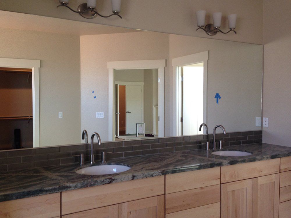 A bathroom with two sinks and a large mirror