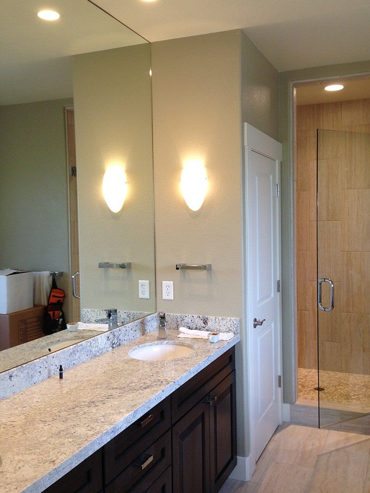 A bathroom with two sinks and a large mirror