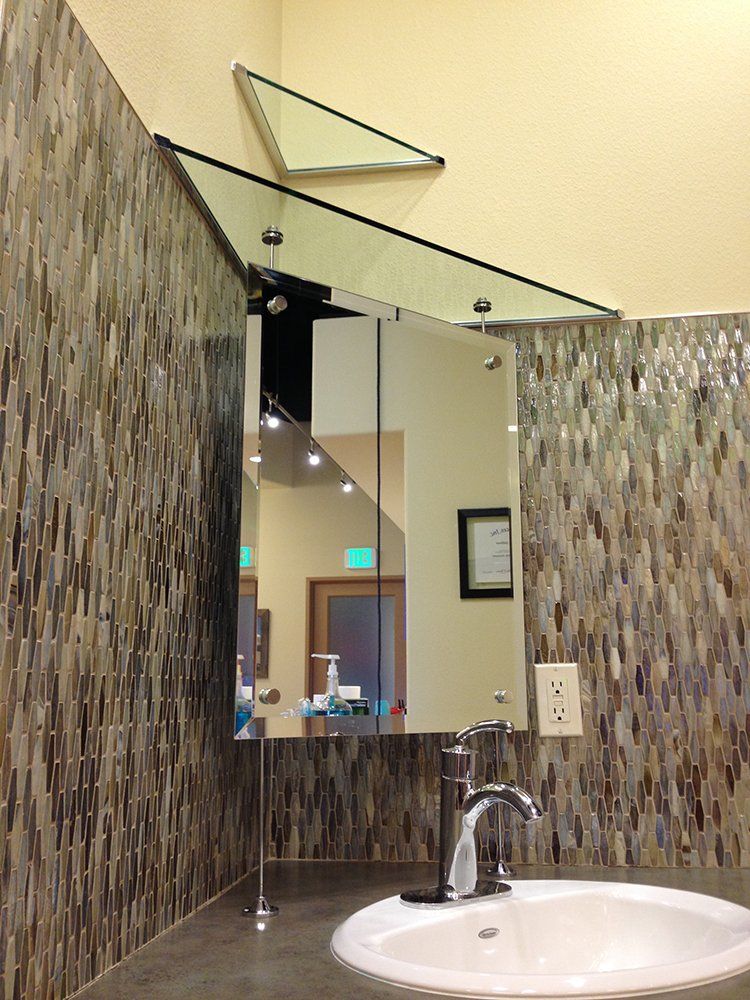 A bathroom with a sink and a mirror on the wall