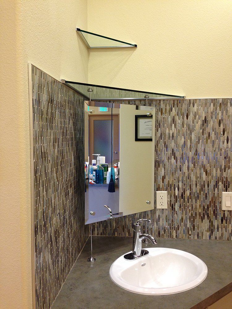 A bathroom with a sink and a mirror on the wall