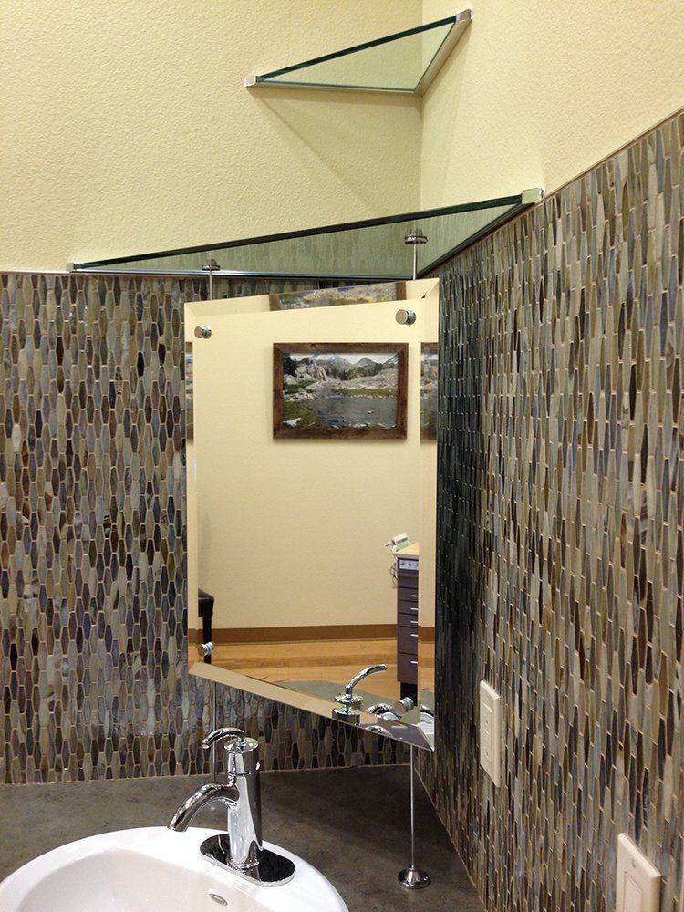 A bathroom with a sink and a mirror on the wall