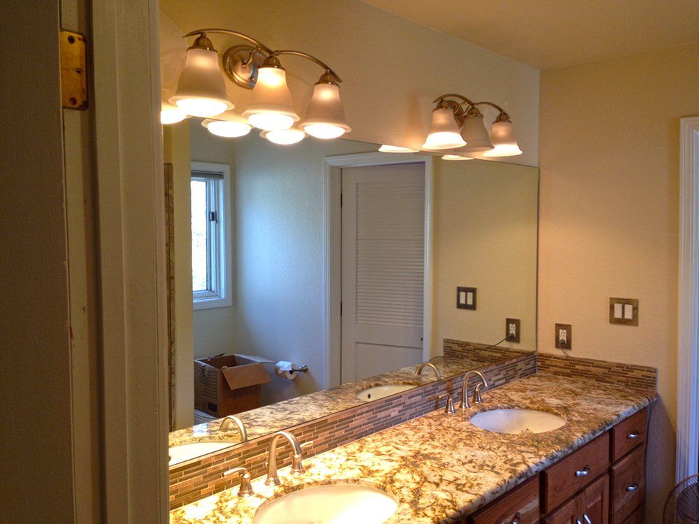 A bathroom with two sinks and a large mirror
