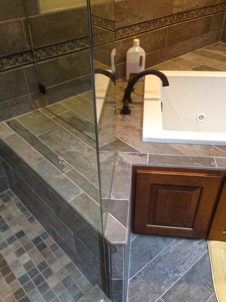 A bathroom with a bathtub and a walk in shower