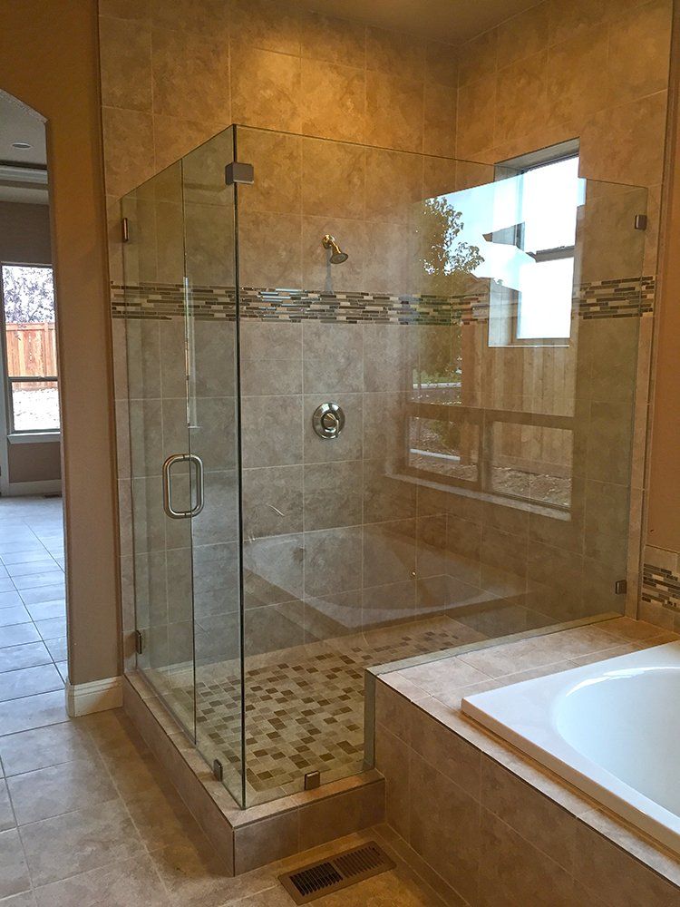 A bathroom with a walk in shower and a bathtub