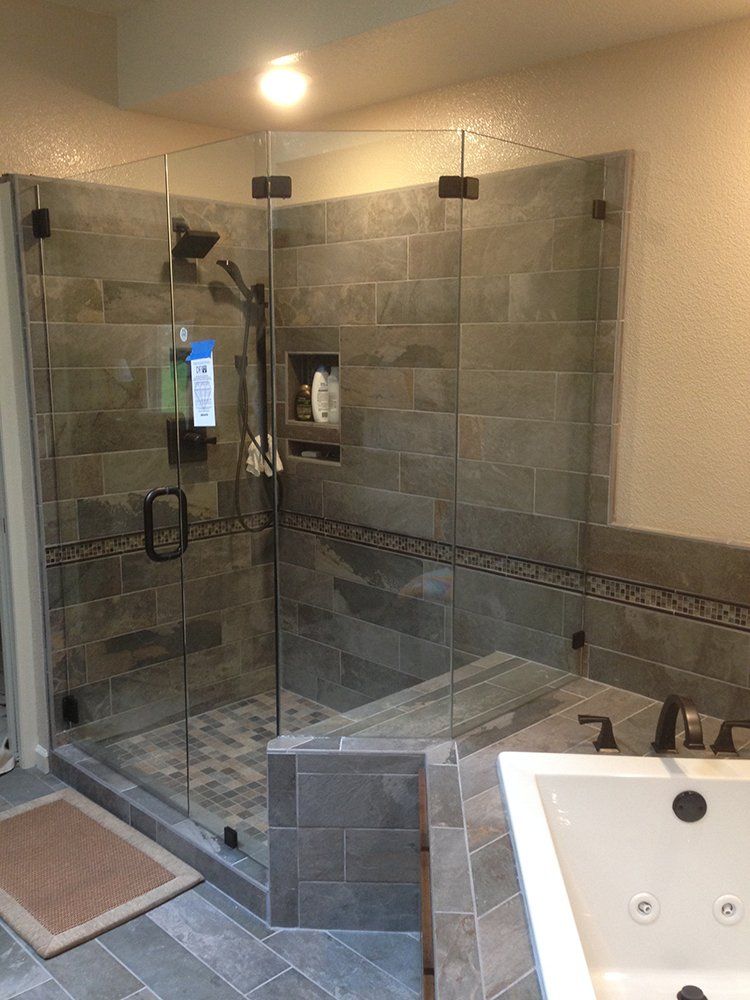 A bathroom with a walk in shower and a bathtub