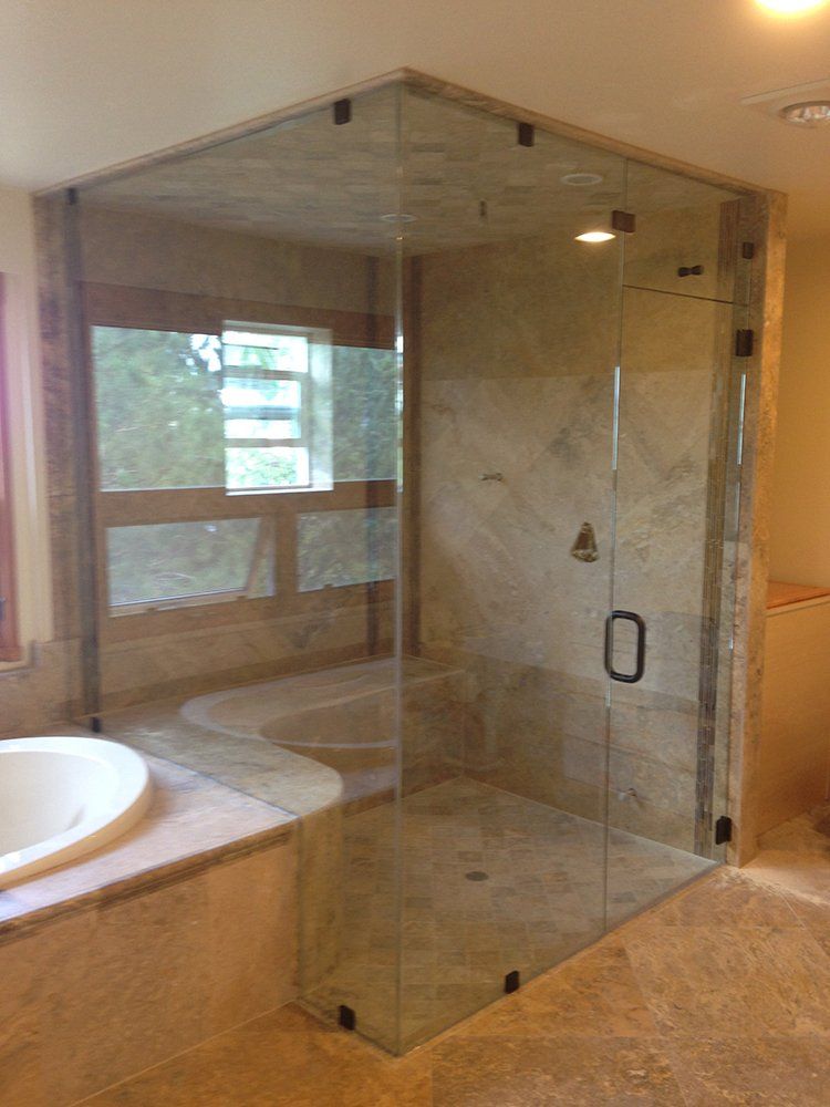 A bathroom with a walk in shower and a bathtub