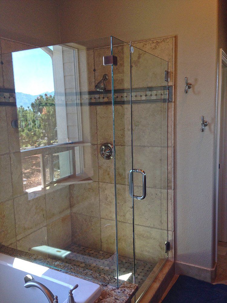 A bathroom with a tub and a shower with a glass door