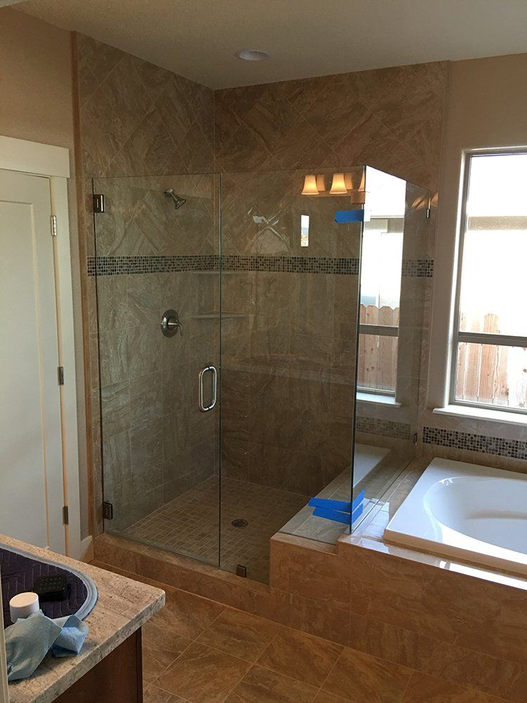 A bathroom with a walk in shower and a bathtub
