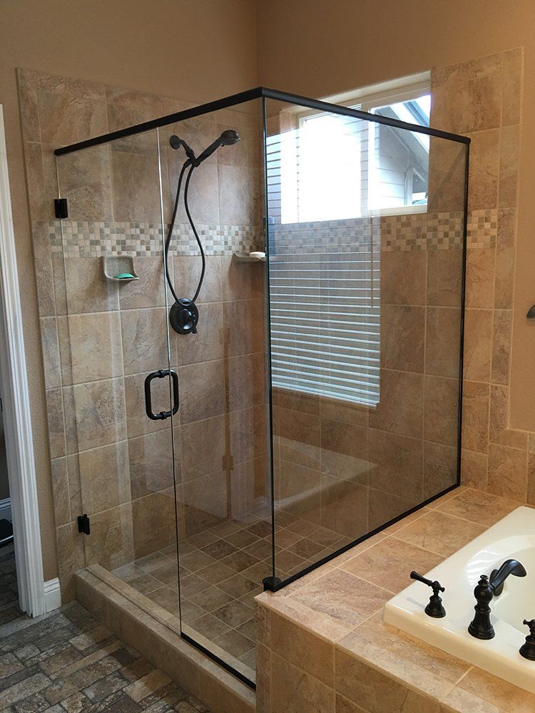 A bathroom with a walk in shower and a bathtub
