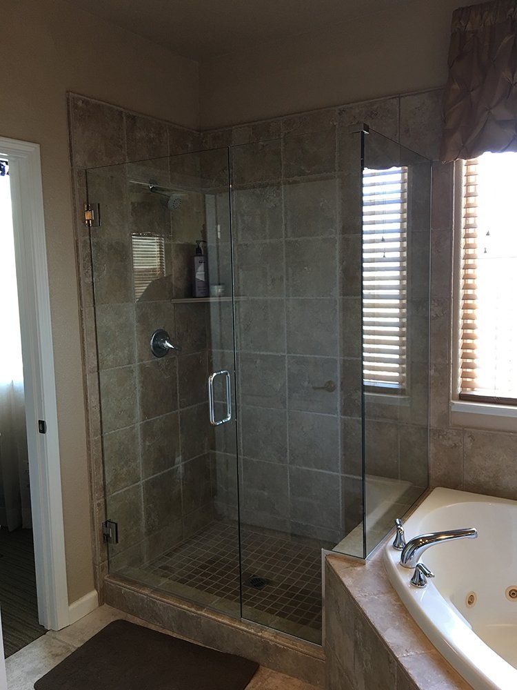 A bathroom with a walk in shower and a bathtub