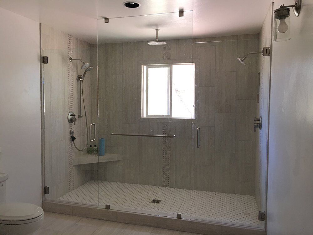 A bathroom with a walk in shower and a toilet