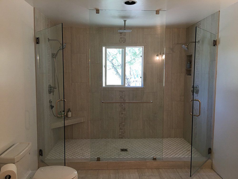 A bathroom with a toilet, shower, and window