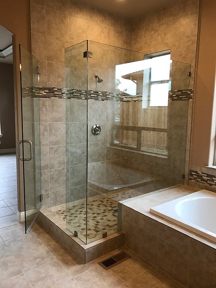 A bathroom with a walk in shower and a bathtub