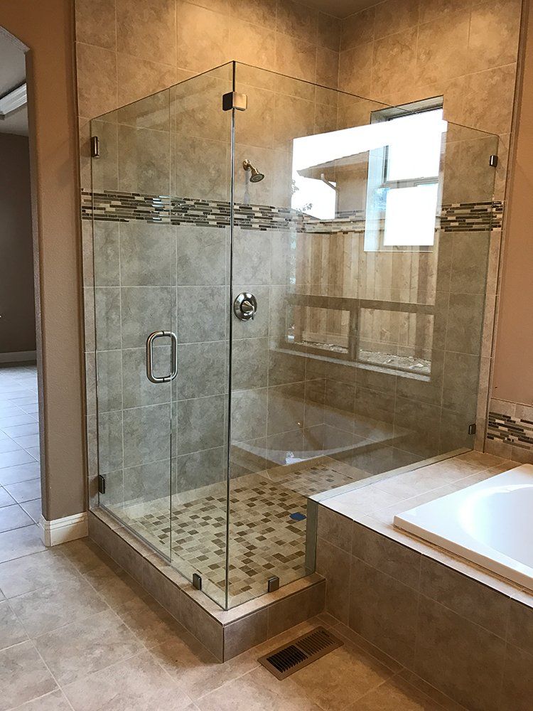 A bathroom with a walk in shower and a bathtub