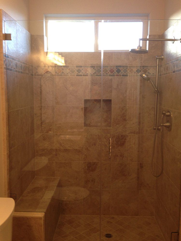 A bathroom with a walk in shower and a toilet