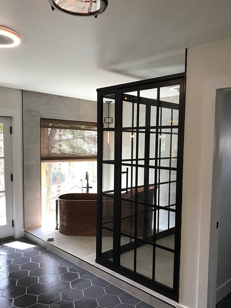 A bathroom with a bathtub and sliding glass doors