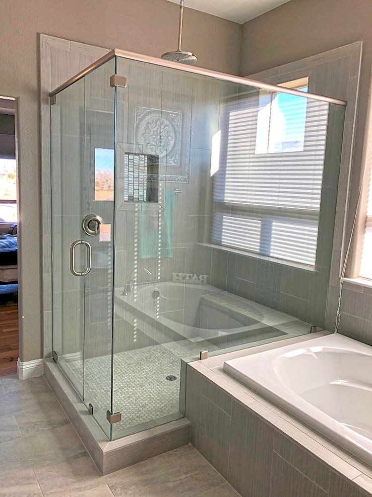A bathroom with a walk in shower and a bathtub