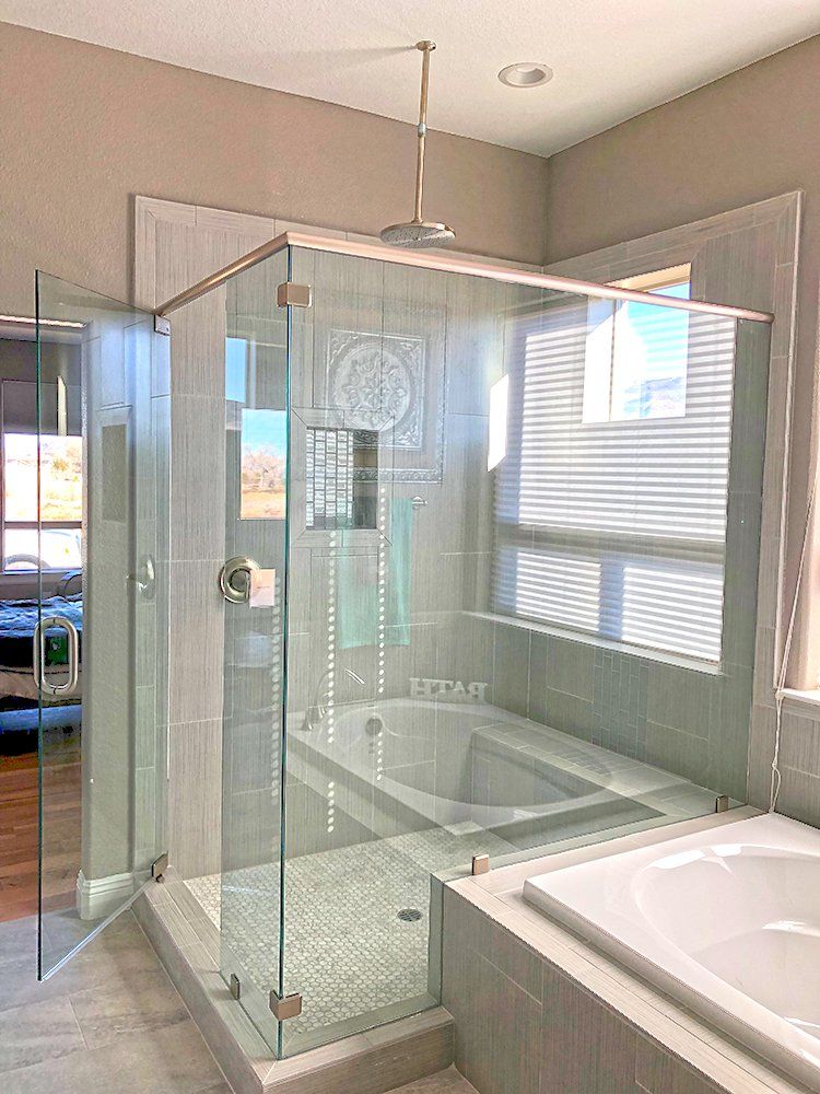 A bathroom with a walk in shower and a bathtub