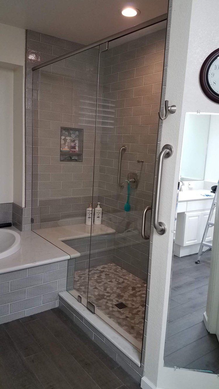 A bathroom with a walk in shower and a bathtub