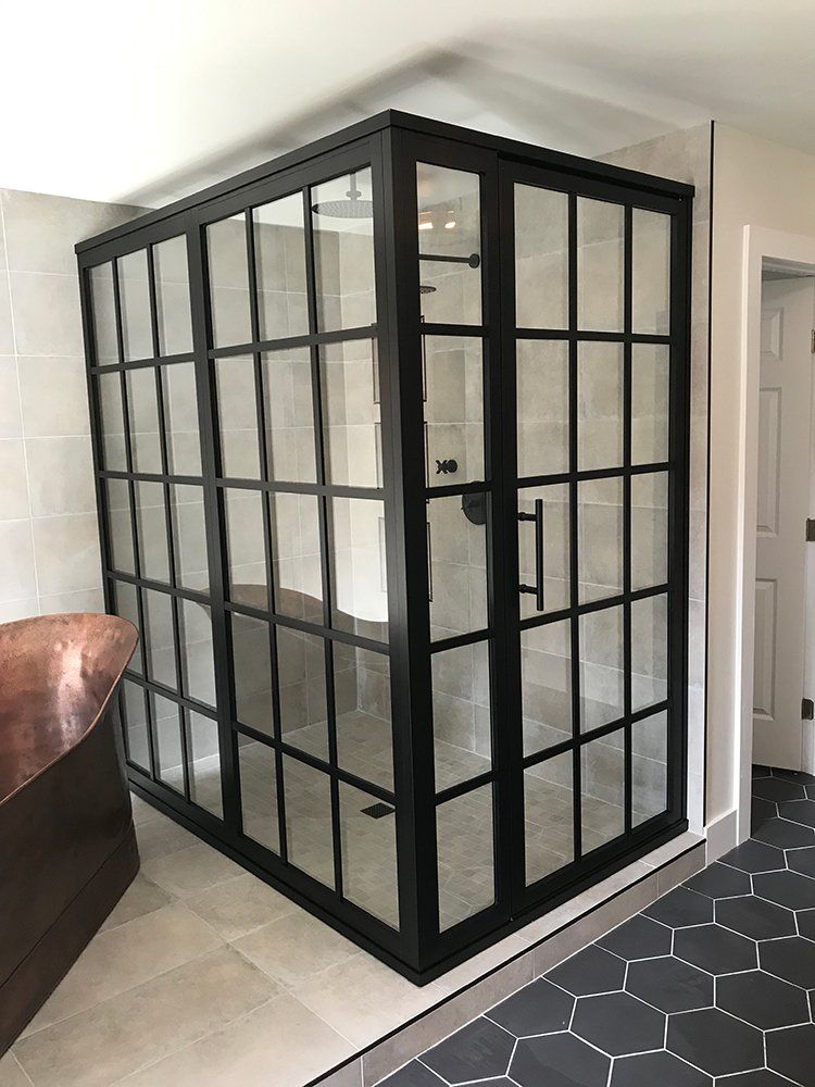 A bathroom with a walk in shower and a bathtub