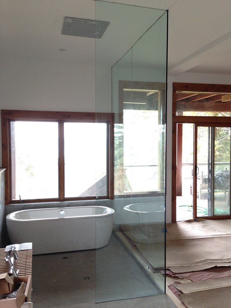 A bathroom with a bathtub and sliding glass doors