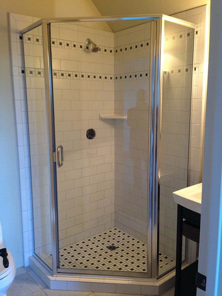 A bathroom with a walk in shower and a toilet