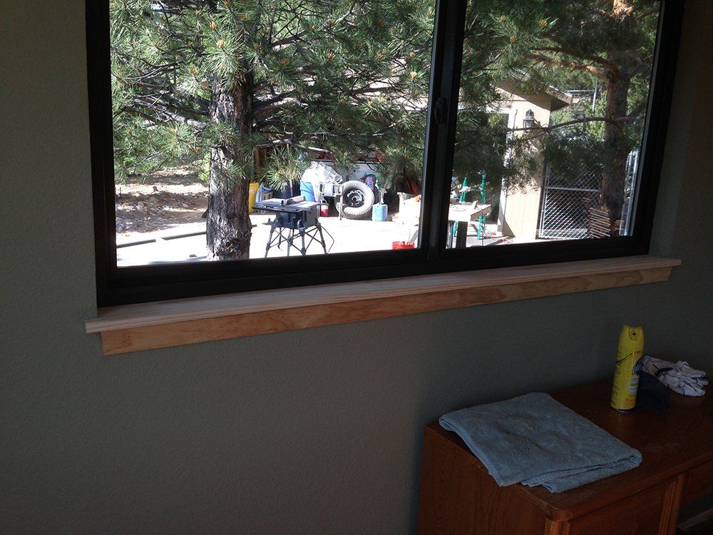 A room with a window and a table with a towel on it