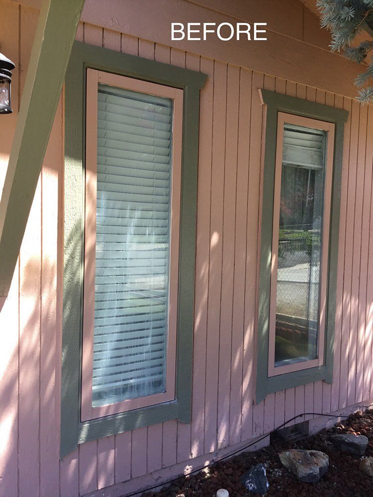 A before picture of a house with pink siding and green trim
