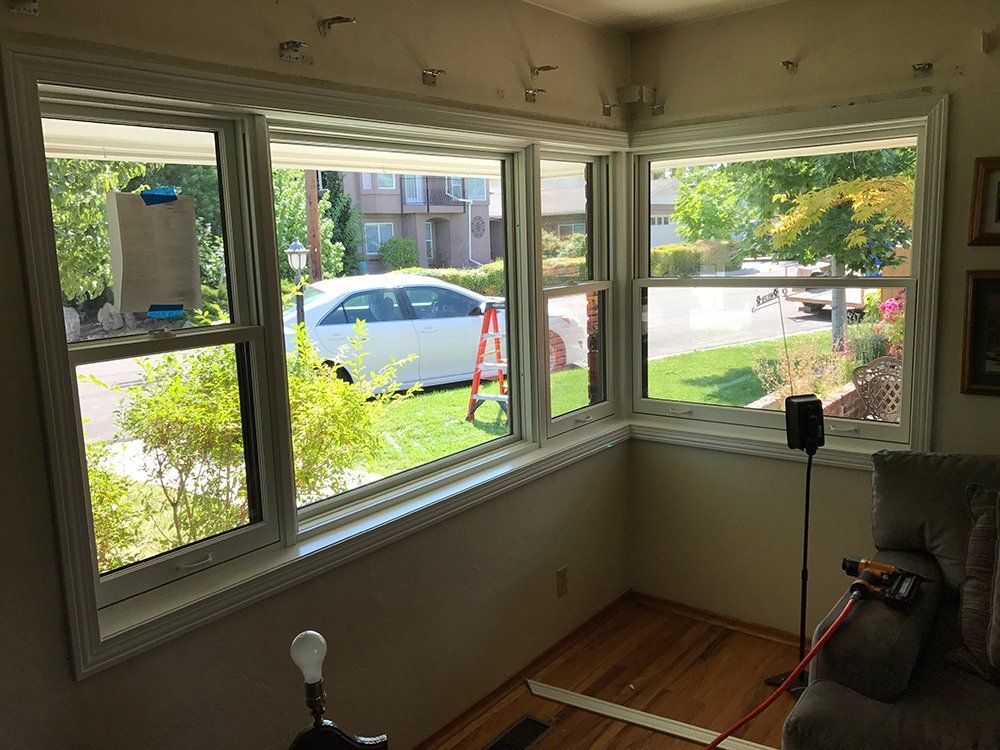 A living room with a lot of windows and a couch