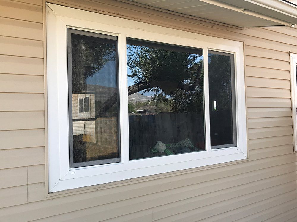 A large white window on the side of a house