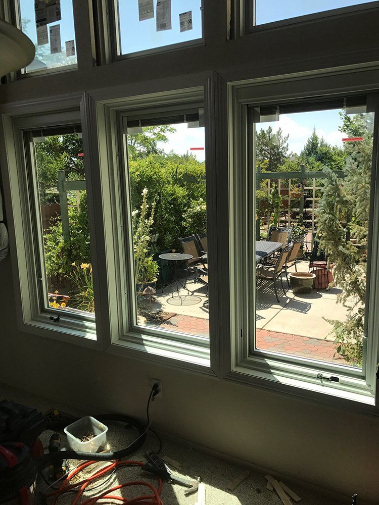 A room with a lot of windows and a view of a patio