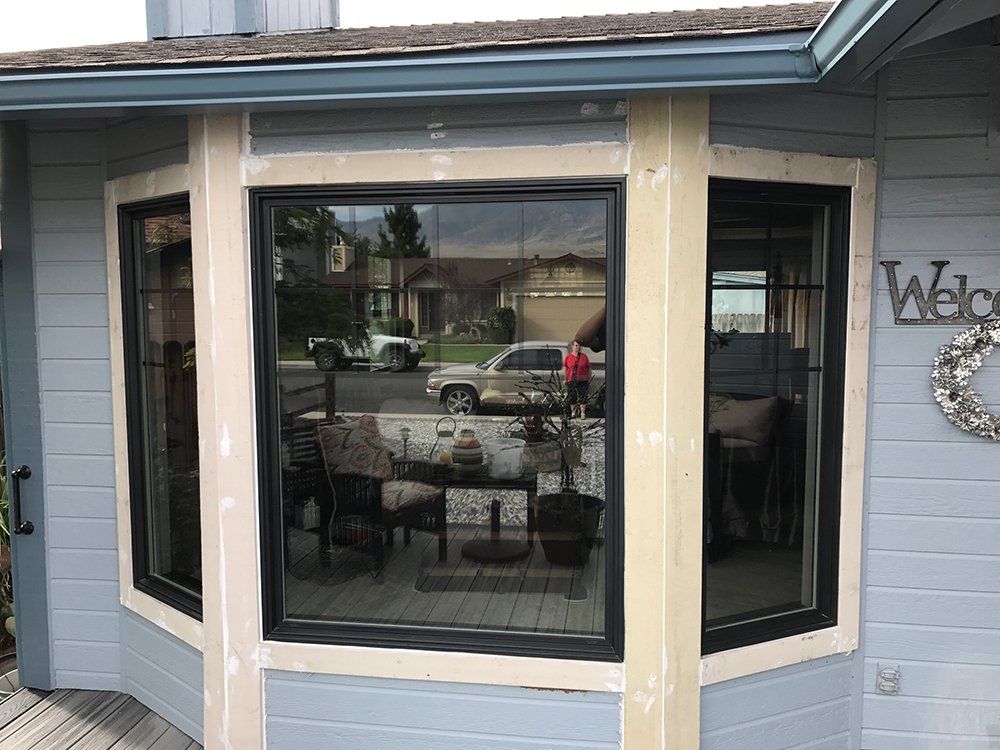 A house with a large bay window and a welcome sign