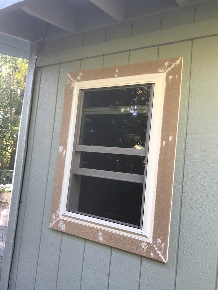 A window is being installed on the side of a building
