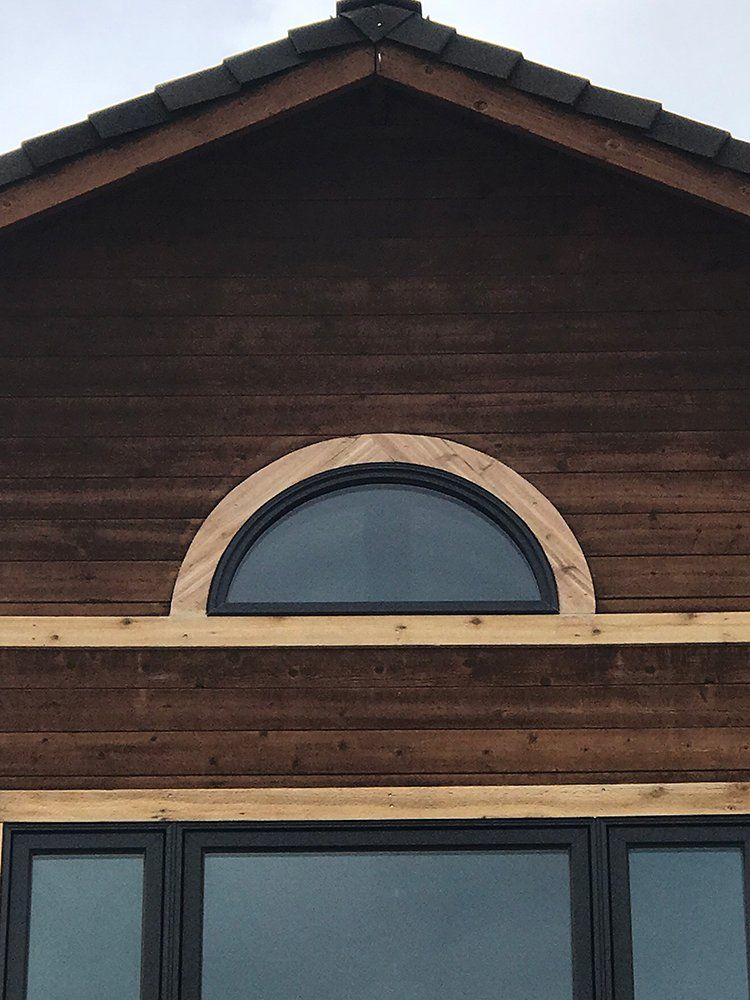 A house with a round window on the side of it