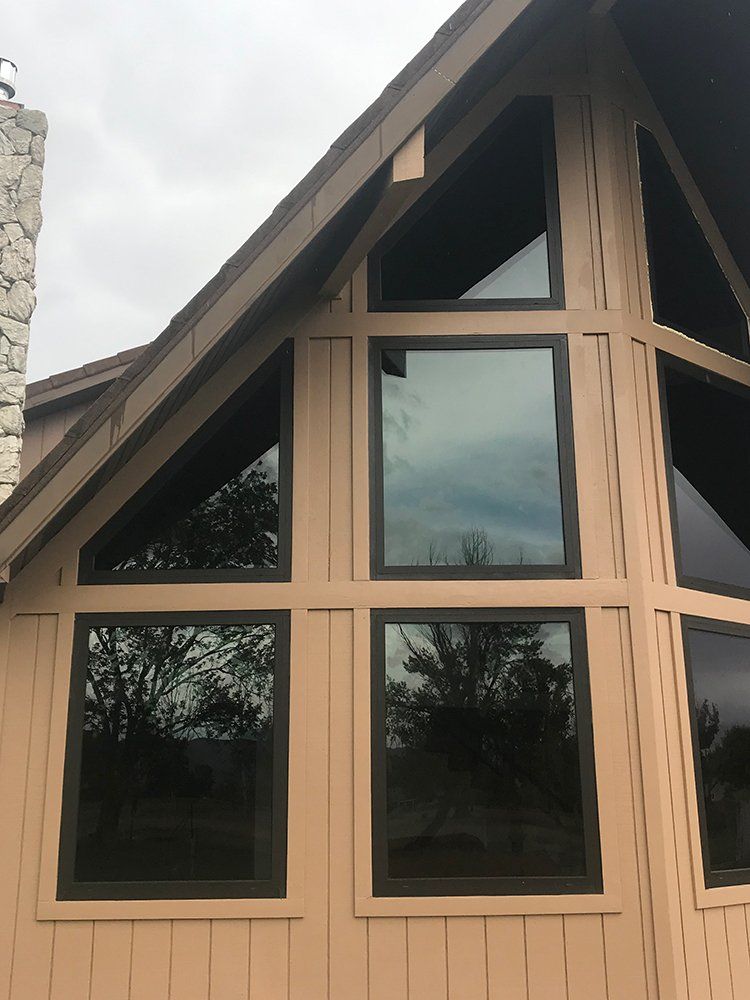 A house with a lot of windows and a chimney